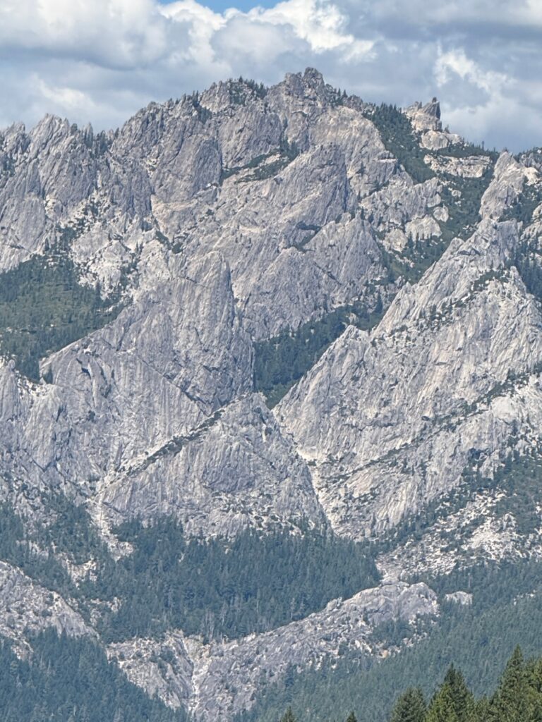The granite spires of Castle Crags rising above a pine ridge